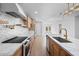 Contemporary kitchen with stainless appliances, marble counters, custom range hood, and wood cabinets at 4400 N 20Th St, Phoenix, AZ 85016