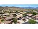 Aerial view showcases the home and surrounding desert community and mountain views at 4423 W Lodge Dr, Laveen, AZ 85339