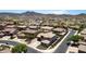 Aerial view of suburban homes in a well-maintained community, desert landscape, and mountains at 4423 W Lodge Dr, Laveen, AZ 85339