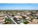 Expansive aerial view of a neighborhood featuring homes with private pools and well-manicured yards against a mountain backdrop at 4423 W Lodge Dr, Laveen, AZ 85339