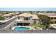 This backyard has a luxurious outdoor living space with a pool, patio, lush lawn, and BBQ kitchen at 4423 W Lodge Dr, Laveen, AZ 85339