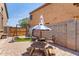 View of a backyard featuring patio area with a table and swing set at 4423 W Lodge Dr, Laveen, AZ 85339