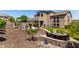 Landscaped backyard features artificial turf, a firepit seating area, and mature landscaping at 4423 W Lodge Dr, Laveen, AZ 85339