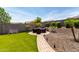 Landscaped backyard features artificial turf, a seating area, and desert landscaping at 4423 W Lodge Dr, Laveen, AZ 85339