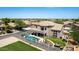 A luxurious outdoor living space featuring a pool, built-in BBQ area, outdoor kitchen, and manicured lawn at 4423 W Lodge Dr, Laveen, AZ 85339