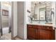 Half bathroom with dark wood cabinet, white countertop, and horizontal tile wall at 4423 W Lodge Dr, Laveen, AZ 85339