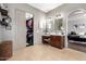 Bathroom featuring a walk-in closet, dual vanity, and spacious countertops at 4423 W Lodge Dr, Laveen, AZ 85339