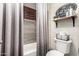 Bright bathroom featuring dark shutters, decorative signs, and gray tile at 4423 W Lodge Dr, Laveen, AZ 85339
