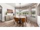 Elegant dining room featuring a modern chandelier, round table, and ample natural light through large windows at 4423 W Lodge Dr, Laveen, AZ 85339