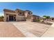 Charming home featuring dual garages, well-maintained landscaping, and a spacious driveway at 4423 W Lodge Dr, Laveen, AZ 85339