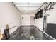 This garage features clean flooring, shelving, storage, and an updated garage door at 4423 W Lodge Dr, Laveen, AZ 85339