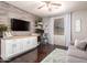 Bright home office featuring wood floors, built-in desk, and comfortable sofa at 4423 W Lodge Dr, Laveen, AZ 85339