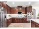 Modern kitchen featuring dark cabinets, stainless steel appliances, and a built-in oven for convenient cooking at 4423 W Lodge Dr, Laveen, AZ 85339