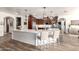 Spacious kitchen with a large center island, modern appliances, and stylish pendant lighting at 4423 W Lodge Dr, Laveen, AZ 85339