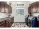 This laundry room features modern cabinets, updated countertops, a window, and a laundry sink at 4423 W Lodge Dr, Laveen, AZ 85339