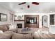 Cozy living room showcasing a fireplace, a modern TV cabinet, and comfortable seating arrangement for relaxation at 4423 W Lodge Dr, Laveen, AZ 85339