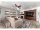 Inviting living room featuring a fireplace, built-in shelves, and plush sectional sofa for comfortable living at 4423 W Lodge Dr, Laveen, AZ 85339