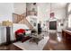 Spacious living room featuring hardwood floors, stairs, and stylish furniture arrangements at 4423 W Lodge Dr, Laveen, AZ 85339