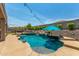 Gorgeous backyard oasis with a pool, rock waterfall, and lush landscaping at 4423 W Lodge Dr, Laveen, AZ 85339
