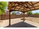 Backyard featuring a wooden gazebo with pavers and fan along with fire pit, and block fencing at 4807 W St Anne Ave, Laveen, AZ 85339