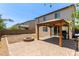 Large backyard with pavers, a fire pit, and a covered patio area perfect for outdoor entertaining at 4807 W St Anne Ave, Laveen, AZ 85339