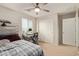 Neutral bedroom featuring a ceiling fan, large closet, and desk by the bright window at 4807 W St Anne Ave, Laveen, AZ 85339