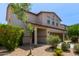 Two-story tan home with well-maintained front yard and landscaped gravel at 4807 W St Anne Ave, Laveen, AZ 85339