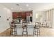 Kitchen with dark wood cabinets, stainless appliances and bar seating at 4807 W St Anne Ave, Laveen, AZ 85339