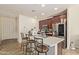 Modern kitchen with stainless steel appliances, a kitchen island and dark wood cabinets at 4807 W St Anne Ave, Laveen, AZ 85339