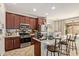 Kitchen with dark wood cabinets, stainless appliances and bar seating at 4807 W St Anne Ave, Laveen, AZ 85339