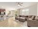 Bright living room featuring a large sectional sofa, tile floors, and sliding glass doors at 4807 W St Anne Ave, Laveen, AZ 85339
