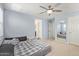 Spacious main bedroom with calming blue walls, a ceiling fan, and ample natural light at 4807 W St Anne Ave, Laveen, AZ 85339
