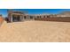 Large, empty backyard with mountain views, block wall, and covered patio at 5023 W Hardtack Trl, Laveen, AZ 85339