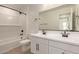 Modern bathroom with double sinks, bath/shower, and white subway tile at 5023 W Hardtack Trl, Laveen, AZ 85339