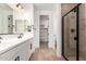 Bathroom featuring double sinks, a shower, and a walk-in closet at 5023 W Hardtack Trl, Laveen, AZ 85339