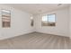 Bright bedroom featuring neutral paint, carpet and large windows at 5023 W Hardtack Trl, Laveen, AZ 85339