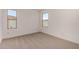 A bright bedroom features neutral carpeting and two view-framing windows at 5023 W Hardtack Trl, Laveen, AZ 85339