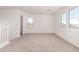 A bonus room with bright natural light, neutral carpeting, and walk-in closet at 5023 W Hardtack Trl, Laveen, AZ 85339