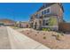 Charming home with a manicured front yard, stone accents, shutters, and a well-maintained lawn at 5023 W Hardtack Trl, Laveen, AZ 85339