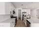 Open kitchen features white cabinets, stainless steel appliances, large island and pantry at 5023 W Hardtack Trl, Laveen, AZ 85339