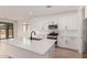 Open kitchen featuring white cabinets, stainless steel appliances, large island and quartz countertops at 5023 W Hardtack Trl, Laveen, AZ 85339