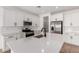 Bright kitchen featuring white cabinets, stainless steel appliances, quartz countertops and a pantry at 5023 W Hardtack Trl, Laveen, AZ 85339
