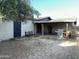 Backyard with a covered patio, built in fire pit, and a bench, perfect for outdoor relaxation at 564 N Santa Anna St, Mesa, AZ 85201