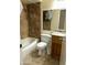 Full bathroom with tile surround tub/shower combo, single sink vanity, and updated fixtures at 564 N Santa Anna St, Mesa, AZ 85201