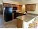 Traditional kitchen offers wood cabinets, granite countertops, and a breakfast bar with seating at 564 N Santa Anna St, Mesa, AZ 85201