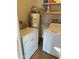 Functional laundry room with a washer, dryer, and water heater for convenience at 564 N Santa Anna St, Mesa, AZ 85201