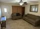 Cozy living room featuring neutral colors, tile flooring, and classic ceiling fan at 564 N Santa Anna St, Mesa, AZ 85201