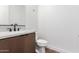 This powder room features a floating vanity with modern fixtures and lighting, along with a contemporary toilet at 5744 E Lowden Rd, Cave Creek, AZ 85331