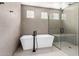 Modern bathroom featuring a glass shower, freestanding tub, and sleek black fixtures at 5744 E Lowden Rd, Cave Creek, AZ 85331