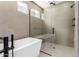 Modern bathroom featuring a glass shower, freestanding tub, and sleek black fixtures at 5744 E Lowden Rd, Cave Creek, AZ 85331